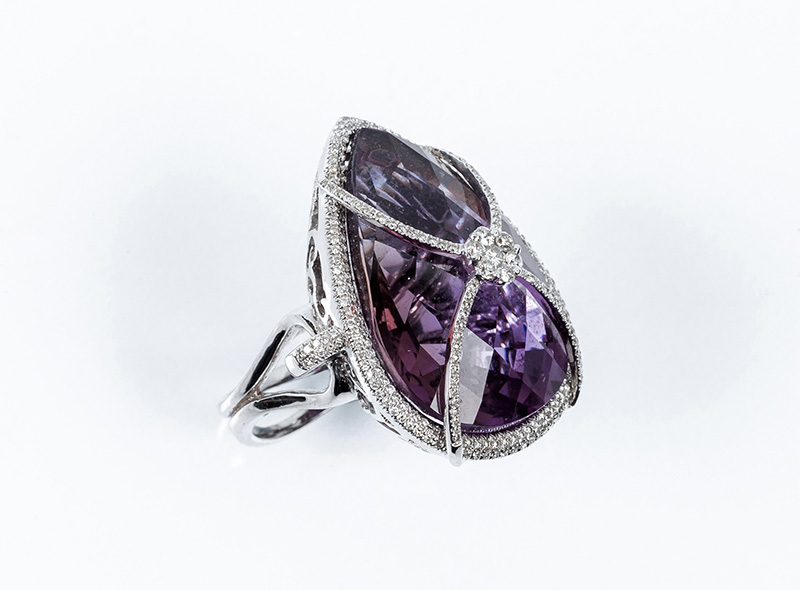 Large high jewelry ring, in a solid white gold setting with a central motif  of goatee amethyst, bordered and embraced in rows of clean, white  brilliant-cut diamonds (175 bts: 1.05 ct approx.